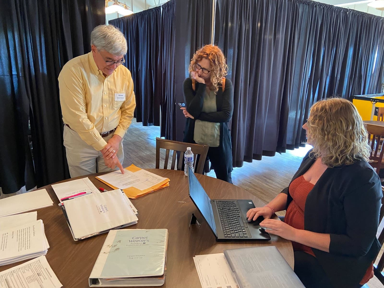 Integrity's Kim House working with Carpet Weaver's employees during a round table discussion.